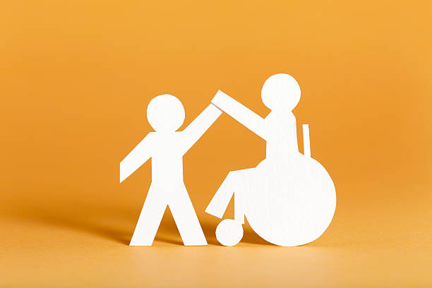 Handicapped person and helper - paper cutouts.